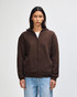 A unisex full zip hooded sweatshirt in dark brown, featuring a hood and a simple design. Includes branding.