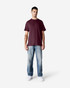 A maroon Gildan Light Cotton T-Shirt worn by a model, paired with light blue jeans and white shoes.