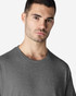 A model wearing a grey Gildan Light Cotton T-Shirt, featuring a simple design and a crew neck.