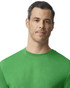 A green Gildan performance adult T-shirt displayed on a model with a neutral expression. The shirt features a logo.