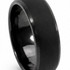 A black carbon fibre ring with a smooth, polished finish and a sleek design. It features a logo.
