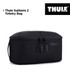 A black Thule Subterra 2 Toiletry Bag with a removable pouch and a logo on the side.