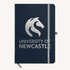 A navy A5 notebook with a branded logo on the cover and an elastic band closure.