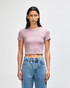 A fitted women's crop T-shirt in light purple, paired with high-waisted blue jeans, featuring a logo.