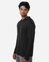 A men's long-sleeve performance polo in black, featuring a hood and a fitted design. It has a logo on the chest.