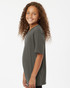 A grey performance polo shirt with short sleeves, featuring a logo on the back. Model displays a side view.
