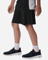 A pair of black athletic shorts worn with a black and red sneaker and white socks. Features a sporty design.
