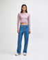 A fitted, long-sleeve crop t-shirt in lilac, paired with blue jeans, worn by a model. The outfit features a casual style.