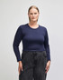 A fitted women's long sleeve crop t-shirt in navy blue, paired with high-waisted black pants. The shirt has a logo.