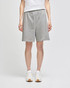 Grey cotton gym shorts with an elastic waistband, featuring a logo and paired with white sneakers.