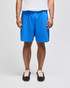 Bright blue cotton gym shorts with an elastic waistband, modelled by a person standing upright.