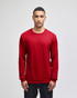 A red long-sleeve t-shirt featuring a logo on the sleeve, presented on a model against a plain background.