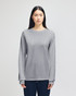 A long-sleeve grey t-shirt with a relaxed fit, featuring a logo on the sleeve.
