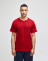 A red Champion adult jersey short sleeve t-shirt displayed on a model with a logo on the sleeve.