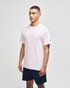 A pink Champion adult jersey short sleeve t-shirt displayed on a model, paired with navy shorts. The shirt features a branding logo.