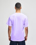 A purple short sleeve t-shirt with a relaxed fit and a logo on the back, showcased on a model.