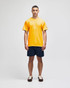 A yellow short sleeve t-shirt worn by a model, paired with navy shorts. The shirt features a small logo.