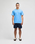 A light blue Champion adult jersey short sleeve t-shirt, worn by a man with navy shorts and brown shoes.