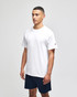 A white short sleeve t-shirt displayed on a model, featuring a logo on the sleeve, paired with navy shorts.