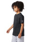 A short sleeve t-shirt in black with a logo on the sleeve, modelled by a child.