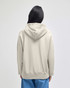 A light grey pullover hooded sweatshirt viewed from the back, featuring a hood and loose fit.