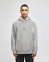 A grey hooded sweatshirt with a front pocket and a logo. Styled with a relaxed fit and drawstrings at the hood.