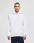 A grey hooded sweatshirt with a front pocket, featuring a logo on the sleeve, worn by a model.