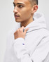 A grey hooded sweatshirt with a logo on the sleeve, featuring a male model looking to the side.