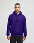 A purple pullover hooded sweatshirt with a front pocket and a logo on the sleeve.