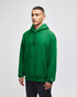 A green hooded sweatshirt with a front pocket and a logo, worn by a model standing against a plain background.