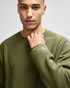 An adult crew sweatshirt in olive green, featuring a logo on the sleeve.