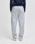 Open-bottom fleece pants in grey, featuring an elasticised waistband and side pockets, worn by a model from the back.