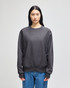 A cropped hoodie in dark grey with a casual fit, featuring a logo on the sleeve.