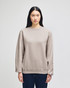 A grey Champion Powerblend® adult crewneck sweatshirt displayed on a model with long dark hair.