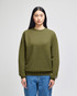 An adult crewneck sweatshirt in olive green, featuring a logo and styled with blue jeans.