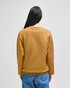 A mustard yellow crewneck sweatshirt featuring a relaxed fit and long sleeves, shown from the back.