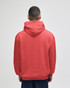 A red crewneck sweatshirt seen from the back, featuring a hood and a logo on the back.