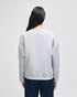 A grey women's crewneck sweatshirt with a relaxed fit, featuring long sleeves and a simple back design.