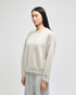 A light grey women's crewneck sweatshirt with a relaxed fit and a small logo on the sleeve.