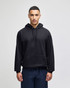 A black pullover hooded sweatshirt with a front pocket and an attached hood, featuring a logo.
