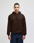 A brown pullover hooded sweatshirt with a front pocket and loose fit, featuring a logo on the chest area.