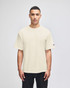 A beige Champion Adult Heritage Jersey T-Shirt displayed on a model, featuring a simple design and short sleeves.