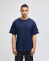 A navy blue Champion Adult Heritage Jersey T-Shirt on a model, featuring a logo on the sleeve.