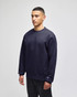 A navy blue Champion Adult Heritage Jersey T-Shirt displayed on a model, featuring a small logo on the sleeve.