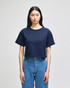 A cropped short sleeve t-shirt in navy blue with a relaxed fit, featuring a logo on the front.