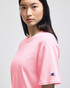 A pink Champion adult short-sleeve T-shirt featuring a logo on the sleeve.