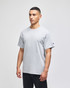 A grey short-sleeve t-shirt featuring a logo, displayed on a model against a neutral background.