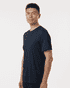 A man wearing a navy men's performance T-shirt, featuring a relaxed fit and minimal design.
