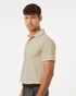 A light beige polo shirt with a collar and short sleeves on a male model, featuring a logo on the chest.