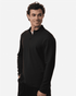 A black men's stretch fleece 1/4 zip top, featuring a zip neck and a relaxed fit, modelled by a smiling man.